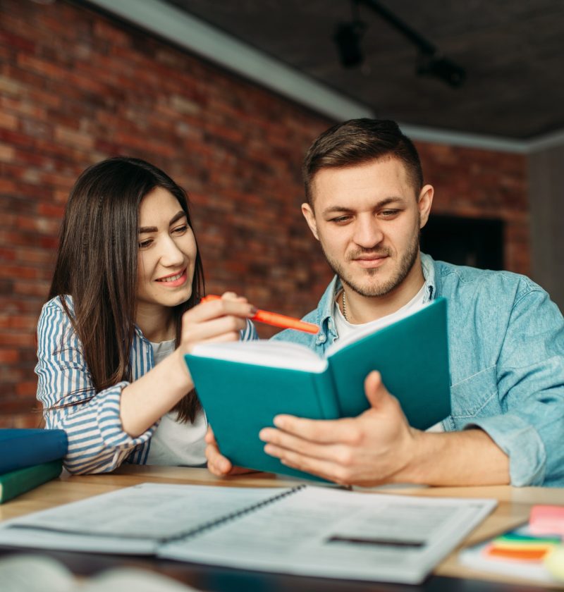 university-students-reading-textbook-together.jpg